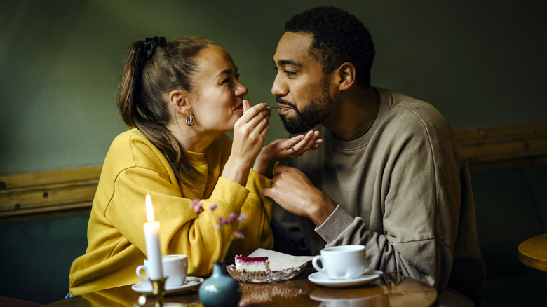 Two people sharing dessert.