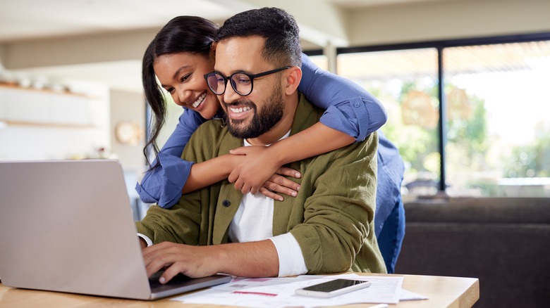 A woman hugging a man.