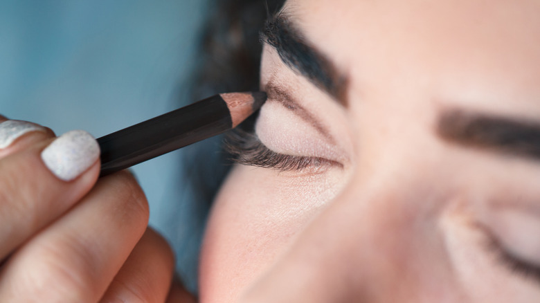 A woman getting her makeup done