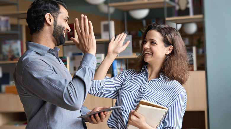 two friends high fiving