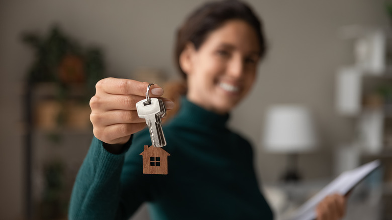 smiling woman holding keys