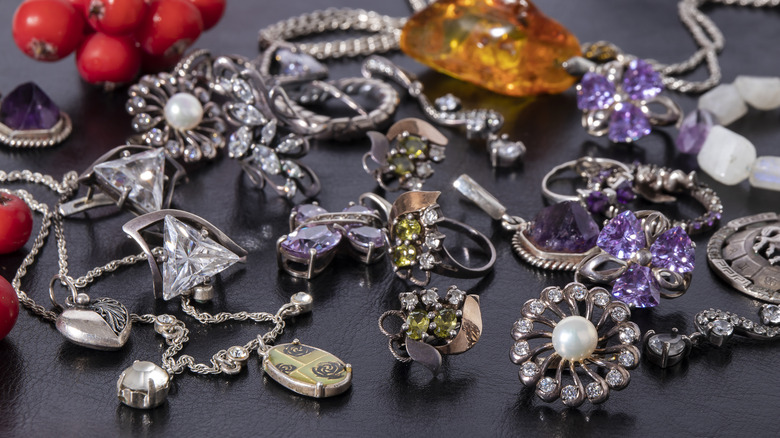 Silver jewelry on black surface