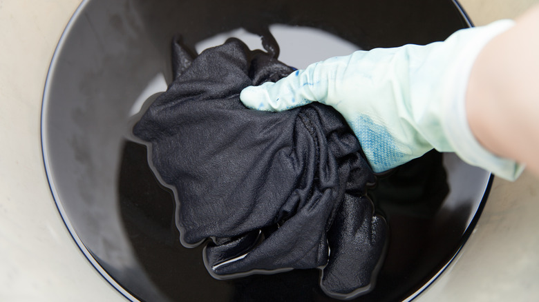 dying clothing in bucket