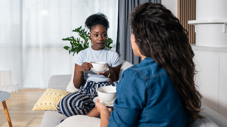 Friends sitting on couch talking