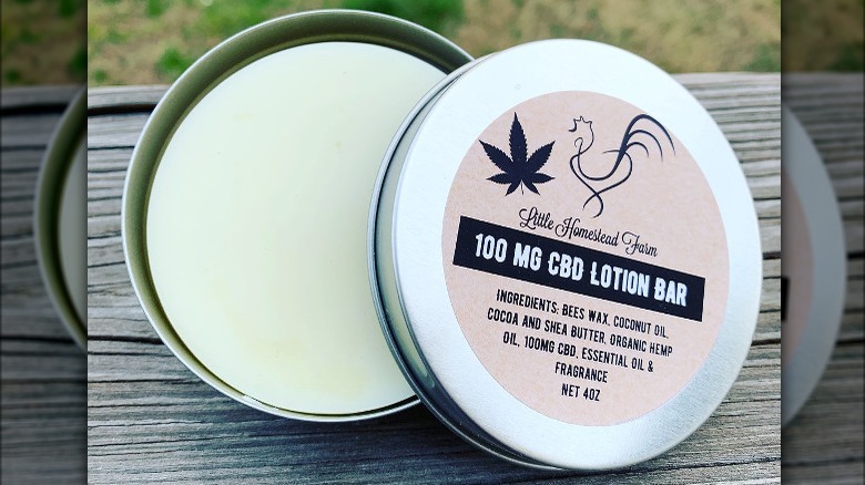 open tin with solid lotion