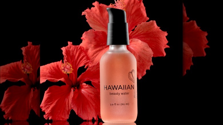 Face serum with hibiscus flowers