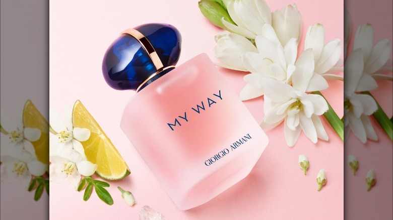 Pink perfume on table