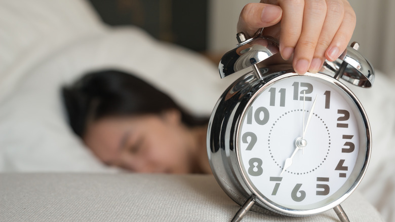 Woman hitting snooze