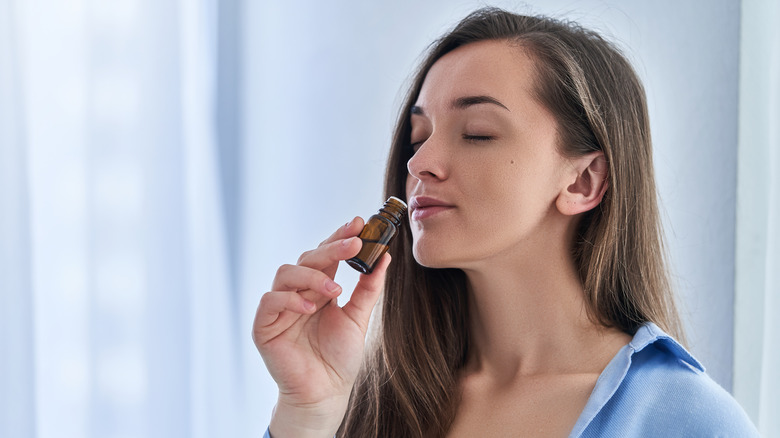 Woman smelling an herbal tincture