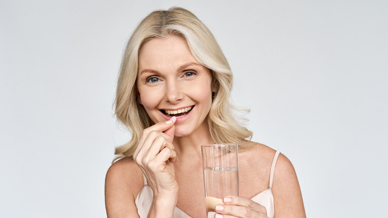 Woman taking a vitamin
