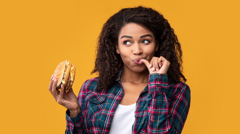 Woman eating hamburger