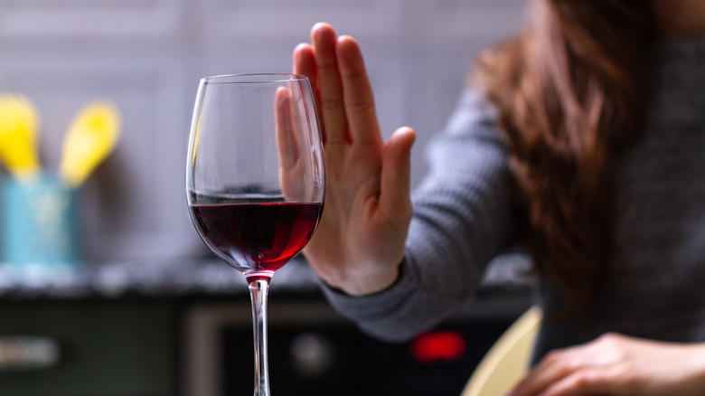 Person refusing a glass of wine