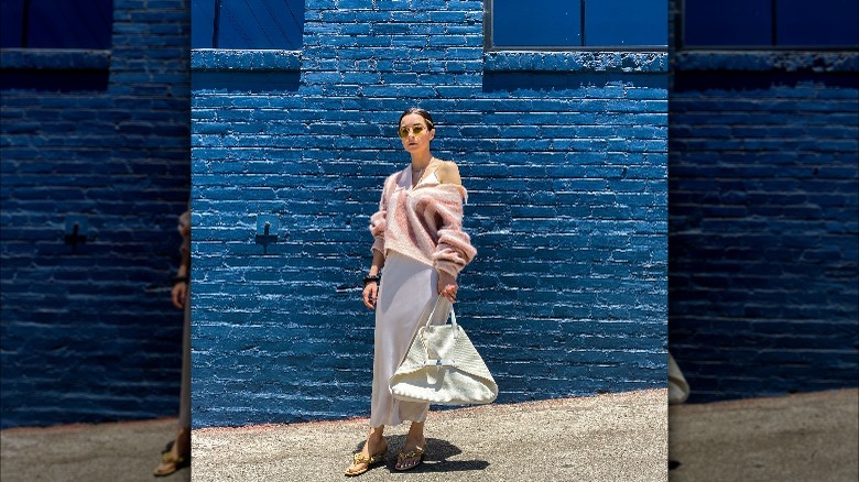 Person in slip dress and gold sandals