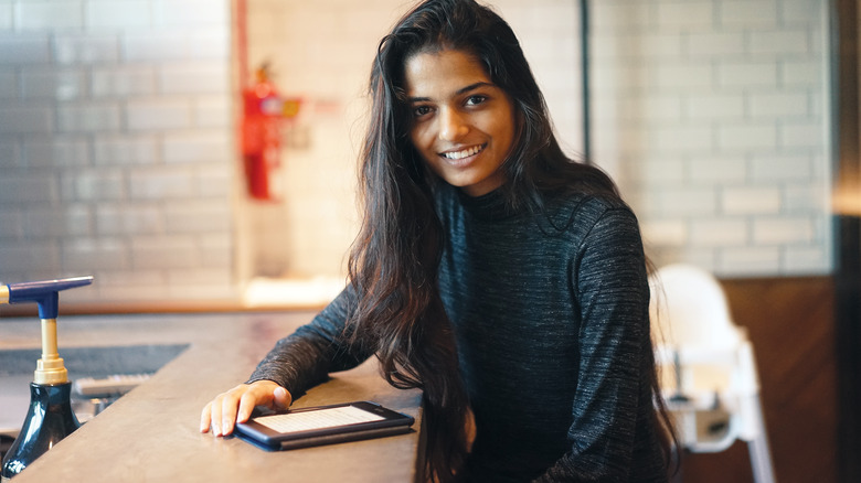 woman reading kindle with smile