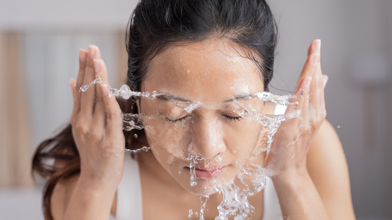 Woman washing her face