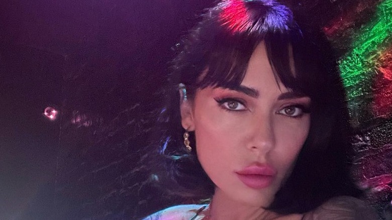 A woman with a short bob and bangs