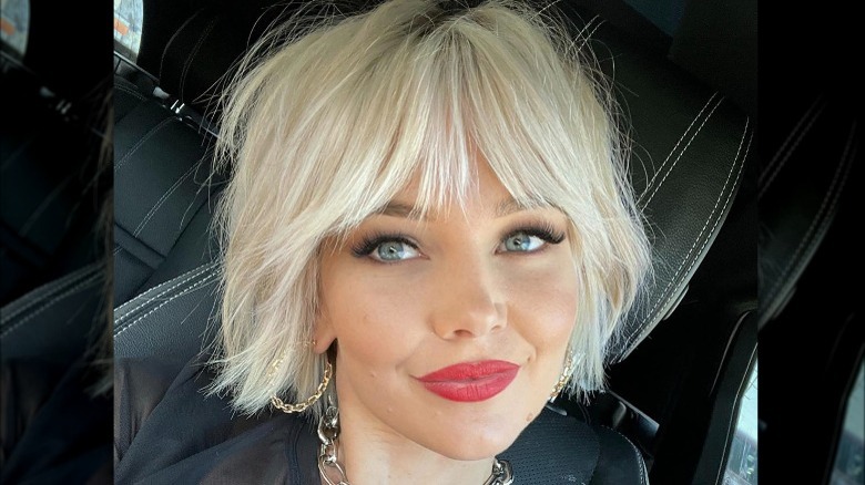 A woman with a mix of a bob and pixie