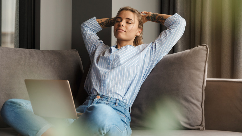 relaxed woman sitting on couch