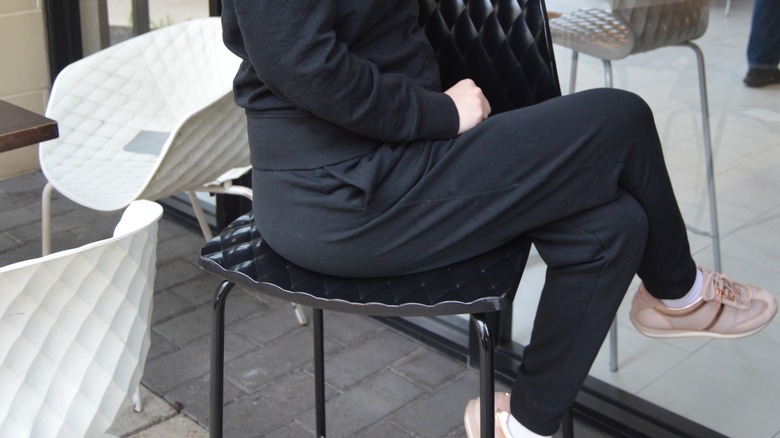 person sitting wearing black sweatsuit