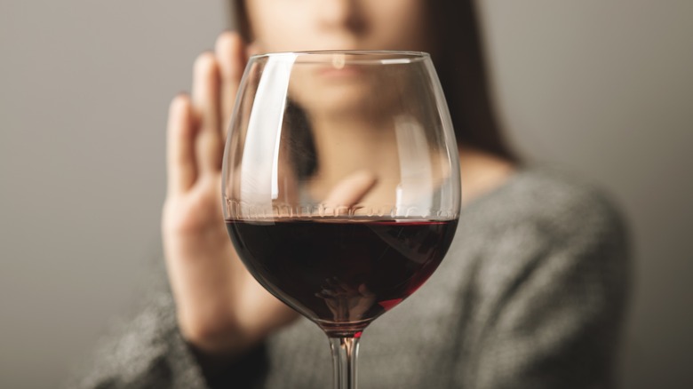 Woman refuses a glass of wine