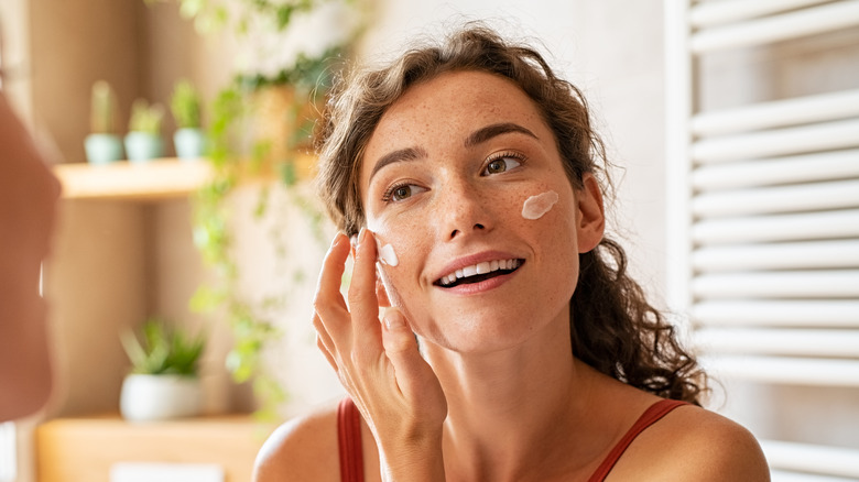 woman using face cream