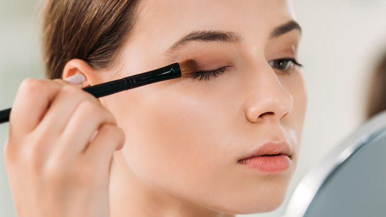 woman applying eyeshadow