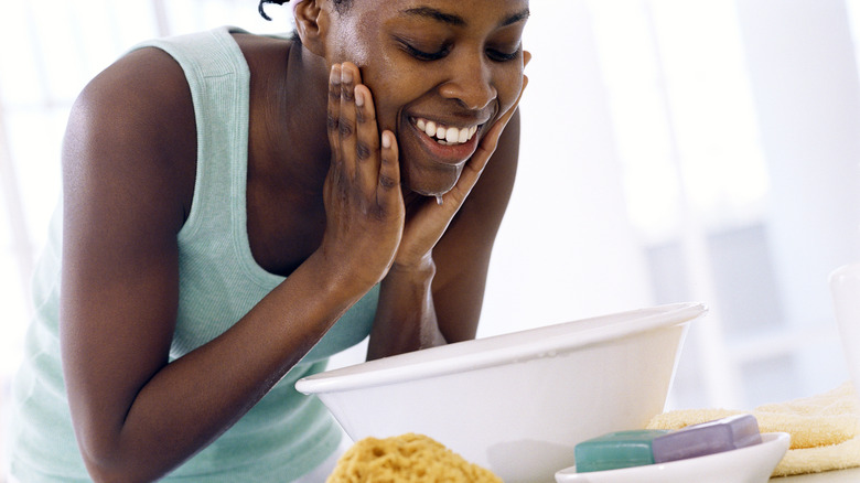 young woman washing face