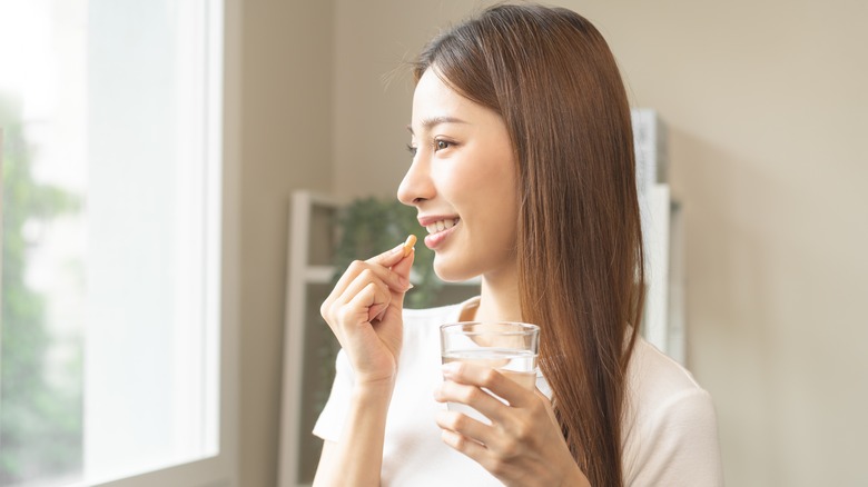 Woman taking her vitamins