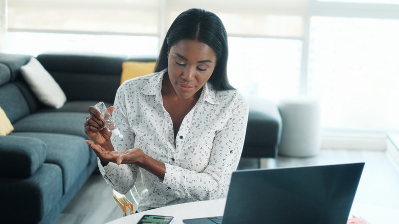 Woman using hand sanitizer
