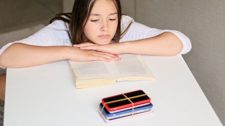 person reading and keeping phone away