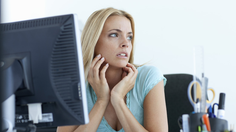 Anxious woman at computer