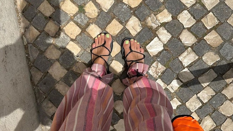 Person with bright green pedicure