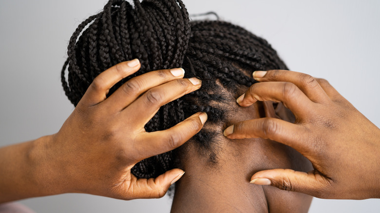woman scratching head