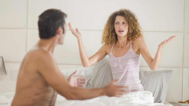 fighting couple in bed