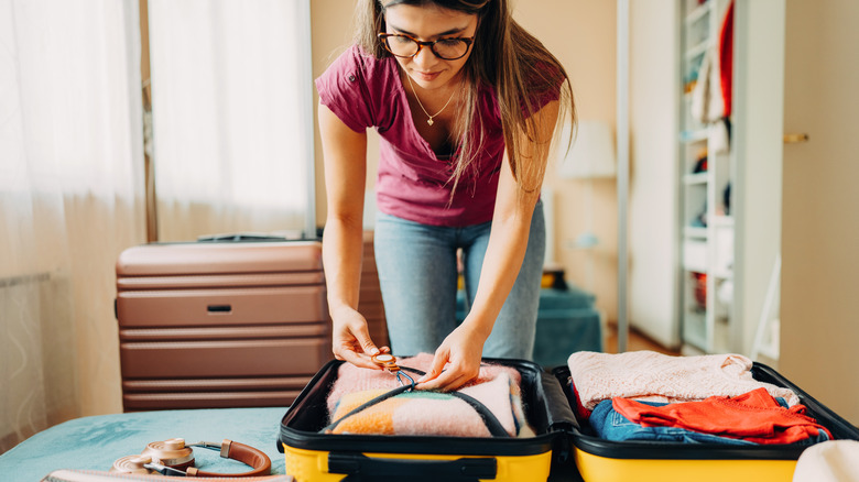 A woman packing her suitcases