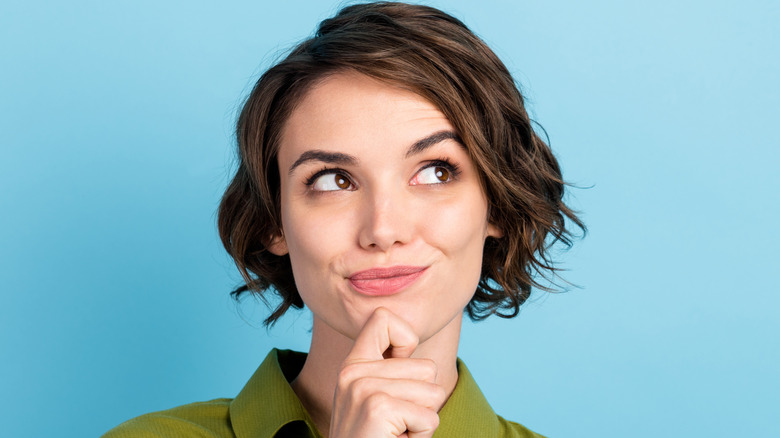 Short haired woman, thinking/smiling