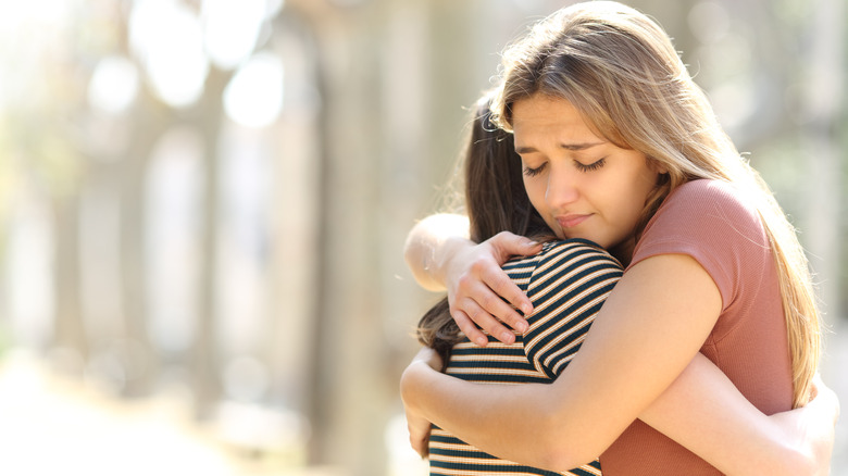 Friends hugging after fight