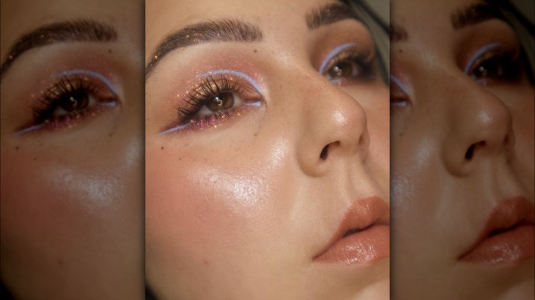 A woman with baby blue graphic eyeliner