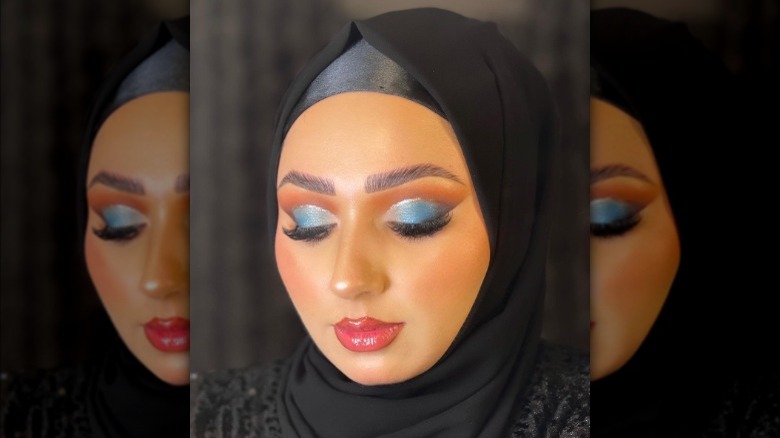 A woman with blue eyeshadow cut-crease