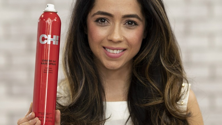 Person holding chi hairspray