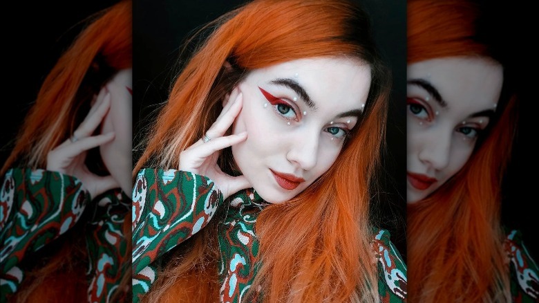 Woman with red eyeliner and pearls