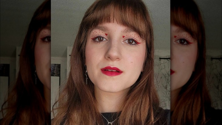 Woman with red eyeliner and hearts