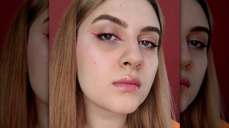 Woman with red eyeliner and dots