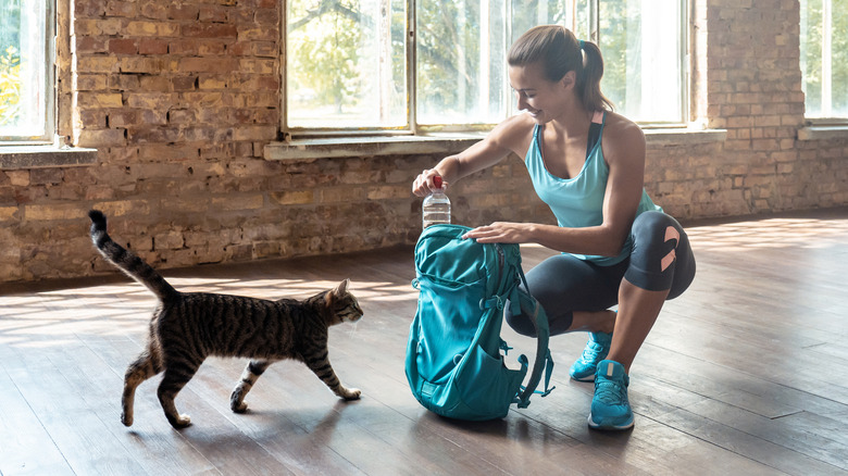 A woman filling a backpack