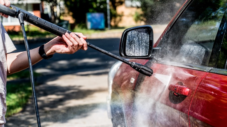person washing red car