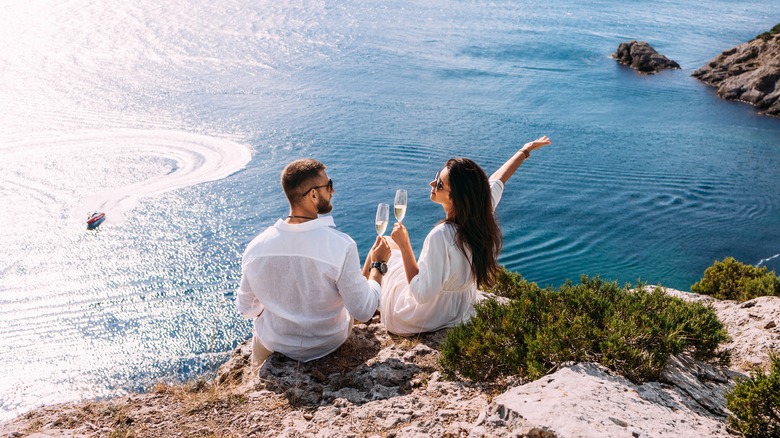 happy couple overlooking beautiful seascape