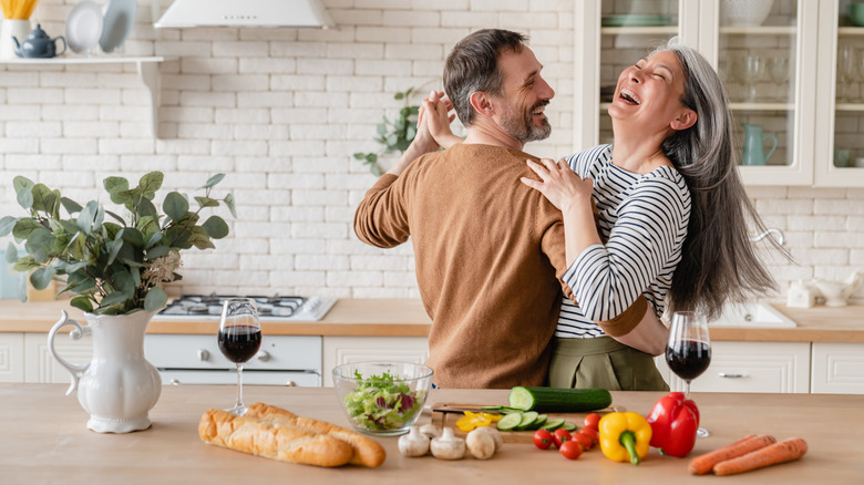 happy couple dancing in kitchen