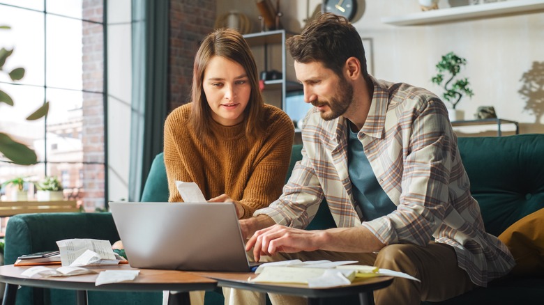 Couple using laptop together