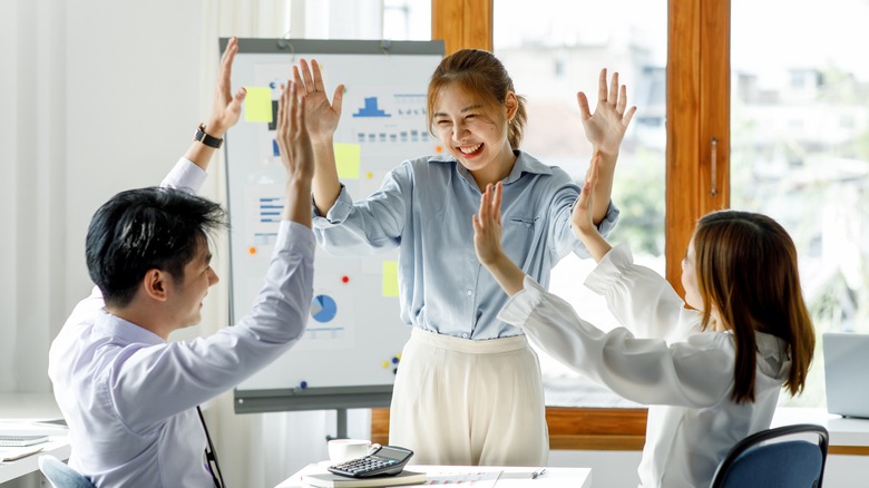 colleagues giving high-fives