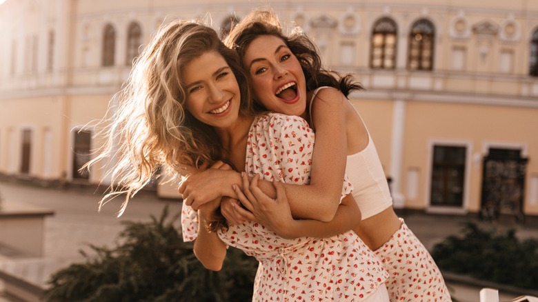 smiling, hugging friends